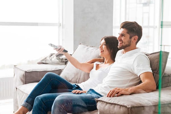 A couple watching an Airbnb tv show