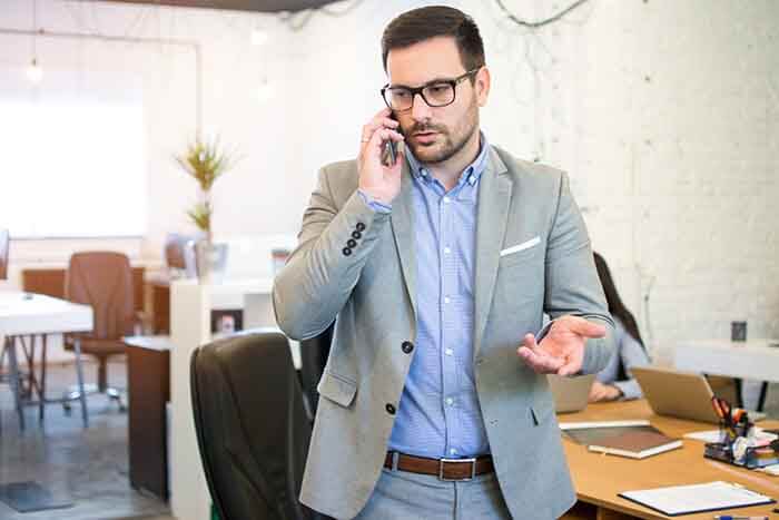 Man dealing with a complaint on the phone